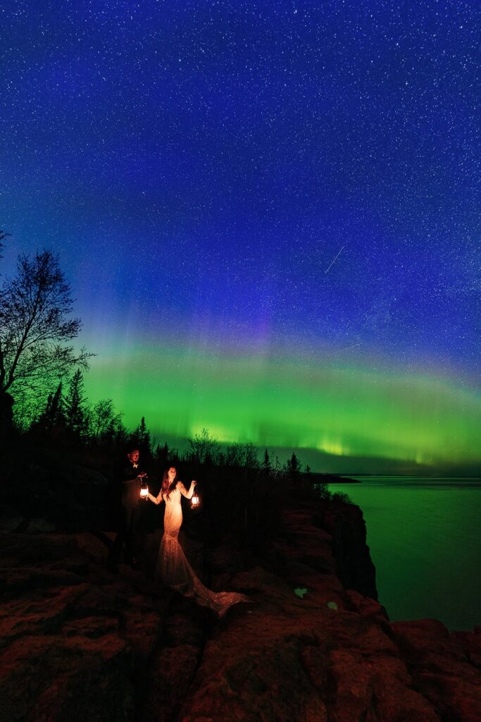 Wedding couple beneath green Northern Lights near Lake Superior on the North Shore