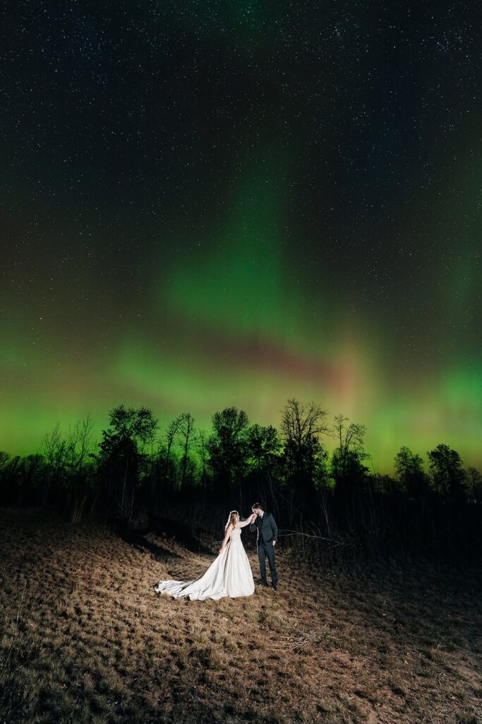 Aurora borealis couple under night sky on Minnesota North Shore