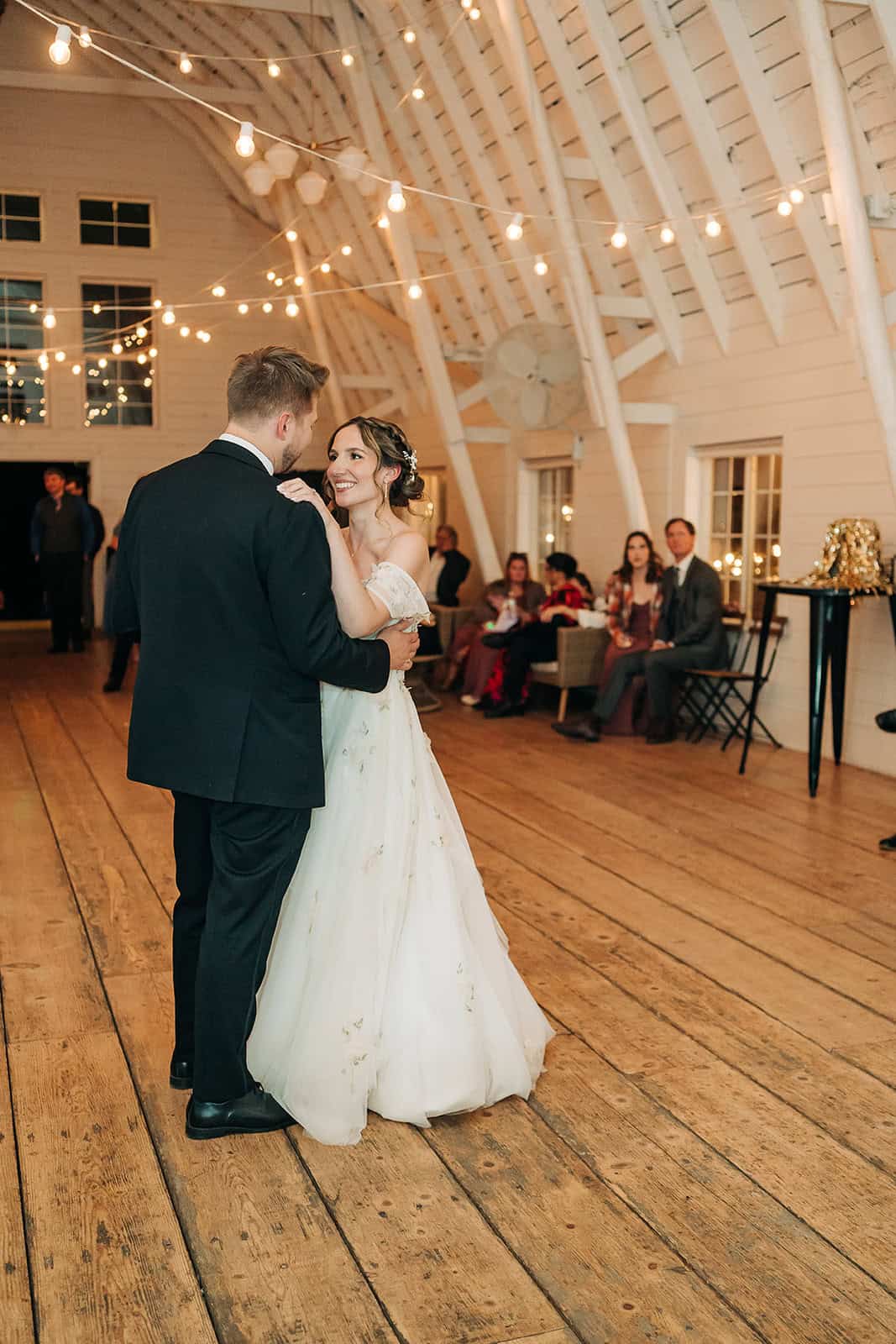 Romantic first dance at Ivory North wedding venue under string lights