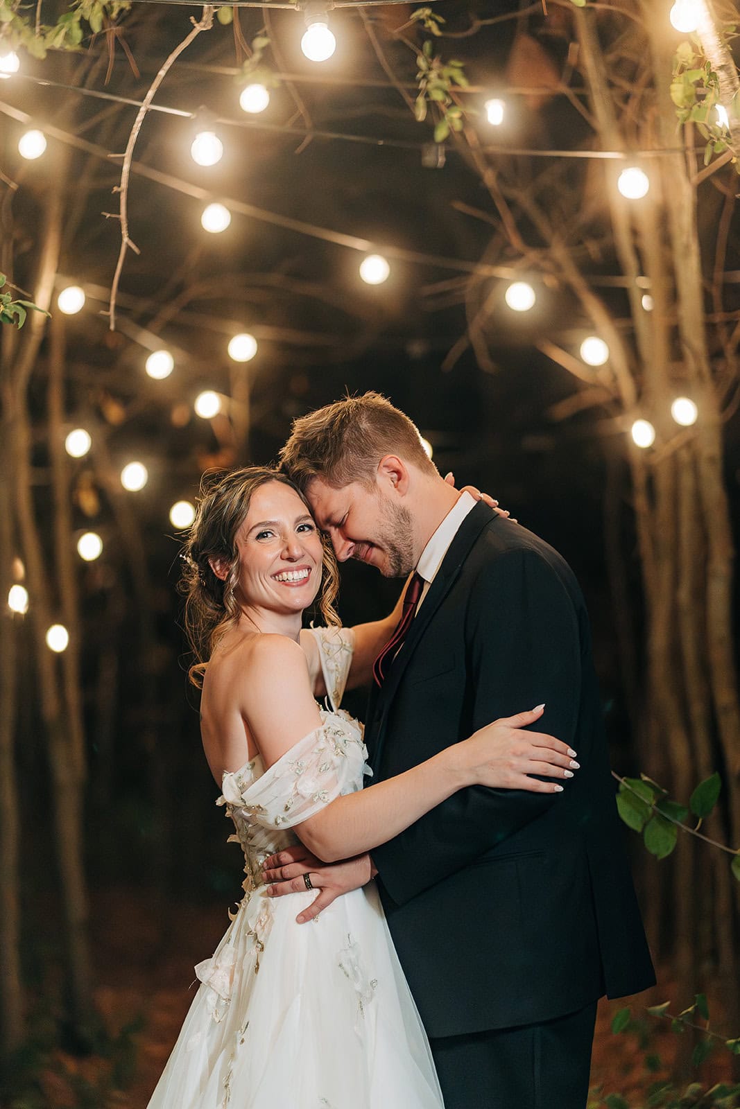 Bride and groom portrait at Ivory North wedding venue under twinkling lights