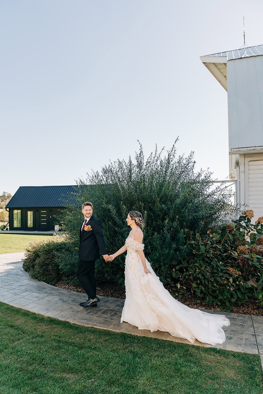 bride and groom exploring ivory north wedding venue hand in hand