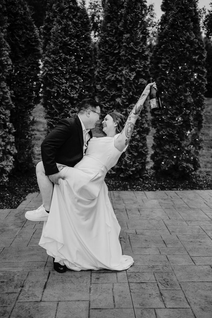 bride and groom popping champagne during minnesota wedding reception