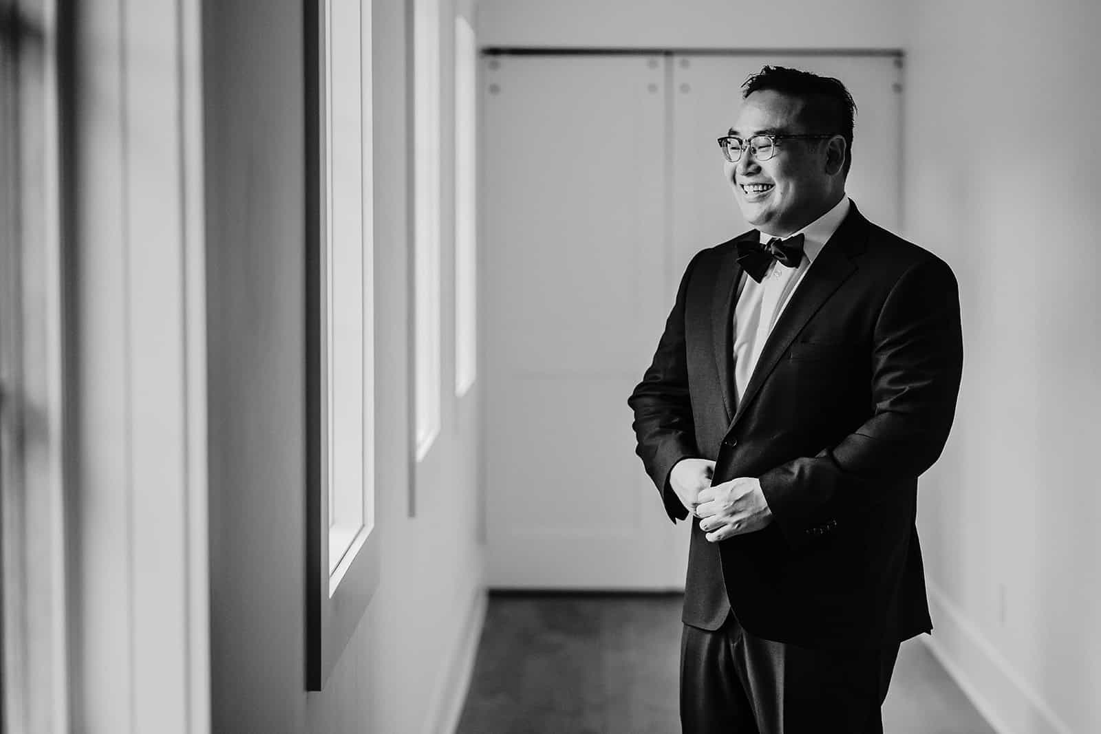 Groom portrait in modern indoor wedding getting ready space