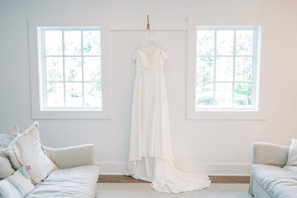 wedding dress on hanger in bride's getting ready area