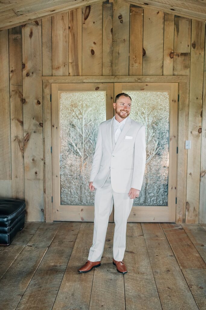 Groom getting ready at Creekside Farm barn in Rush City MN