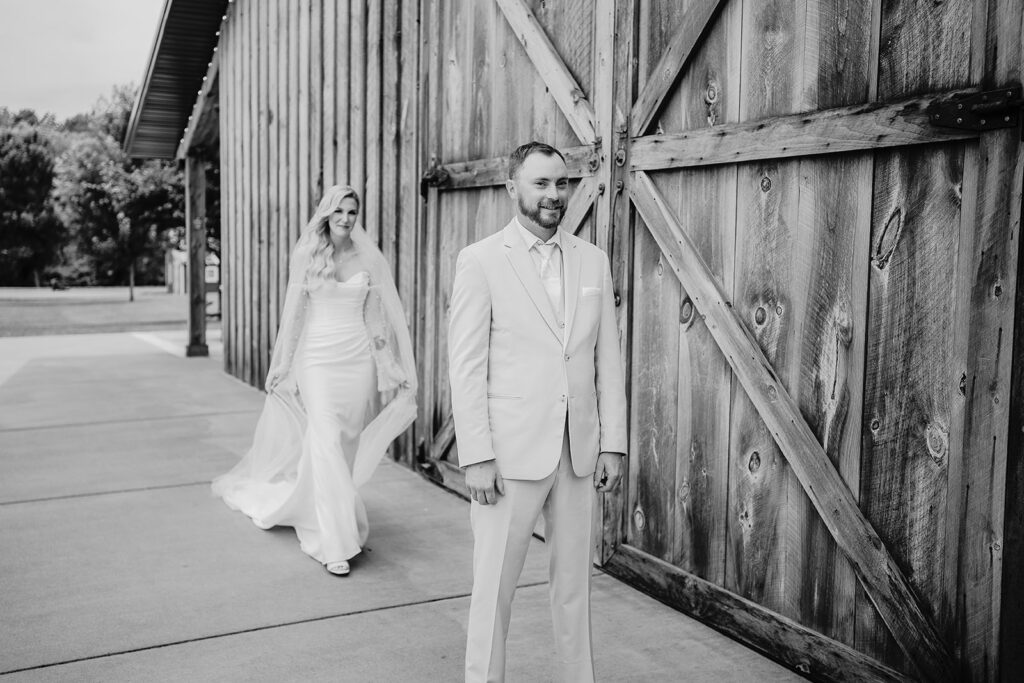 black and white photo of bride and groom just before their first look on wedding day
