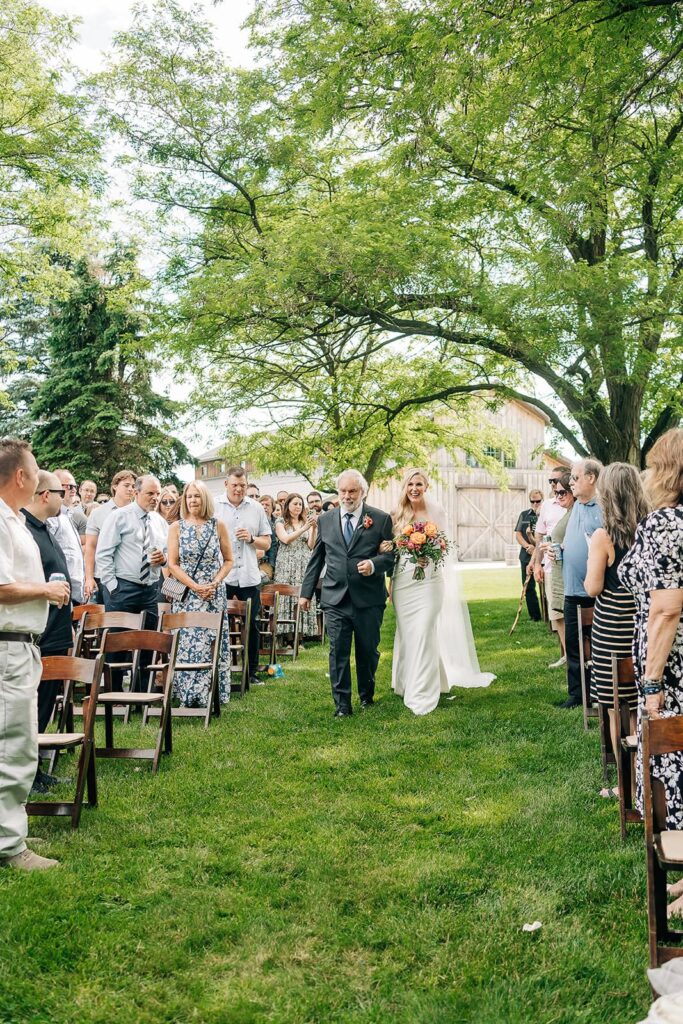 Bride walking down the aisle at Creekside Farm outdoor ceremony