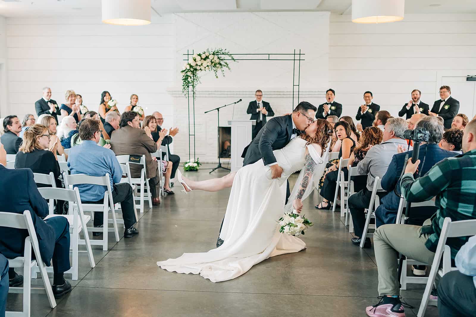 Indoor wedding ceremony at Hutton House with clean white backdrop