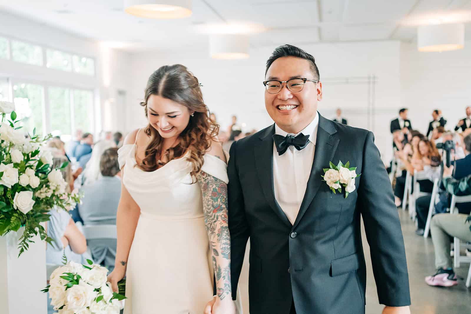 bride and groom walking back down the aisle after mn wedding ceremony