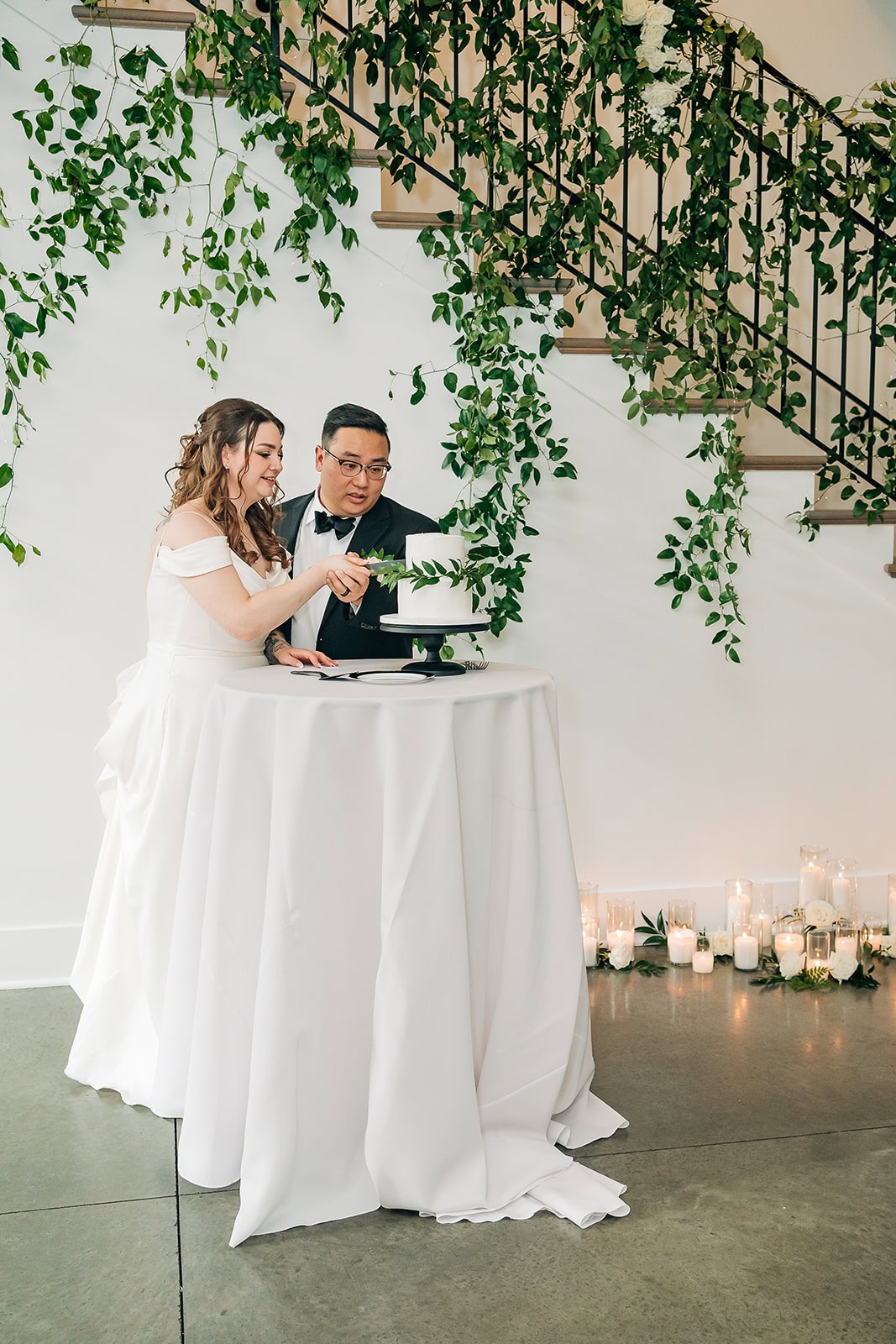 bride and groom cutting cake during minnesota wedding day