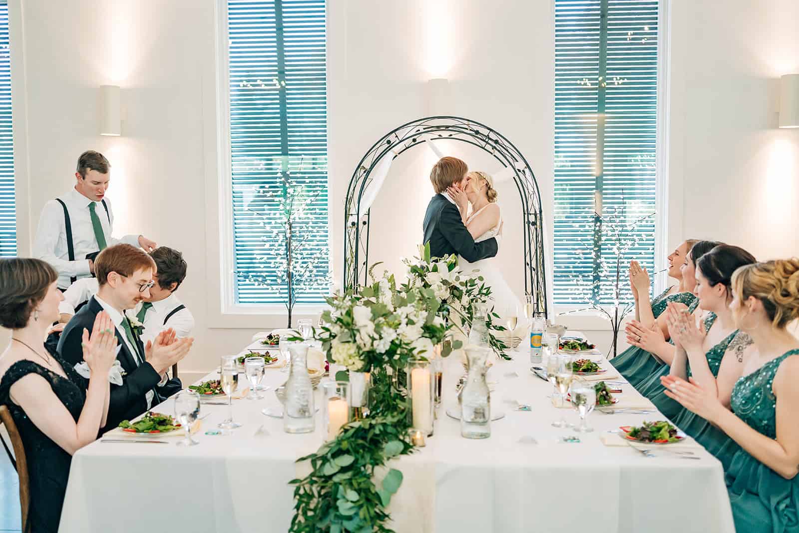 bride and groom share a kiss during their wedding reception in minnesota