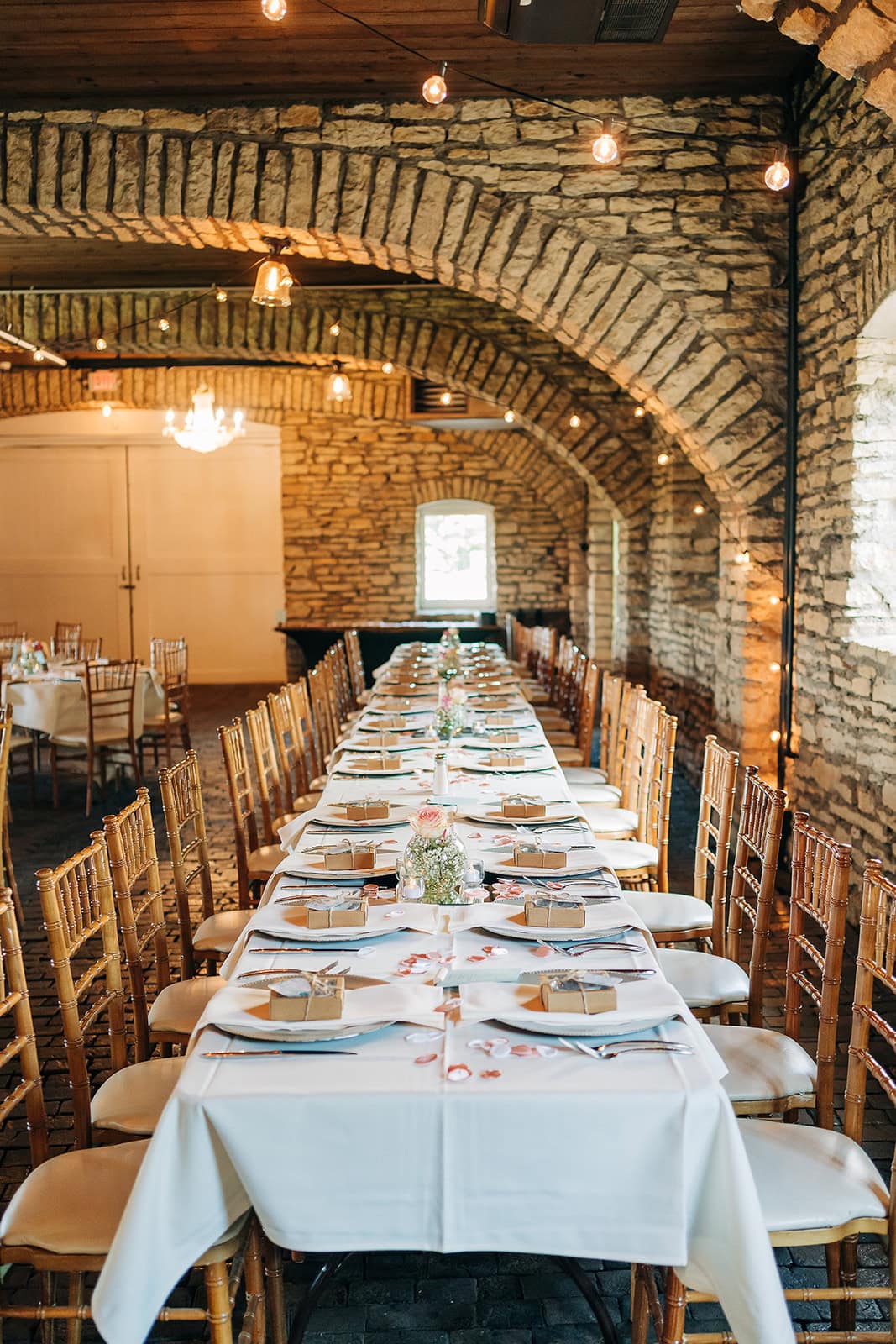 reception tables inside historic stone barn