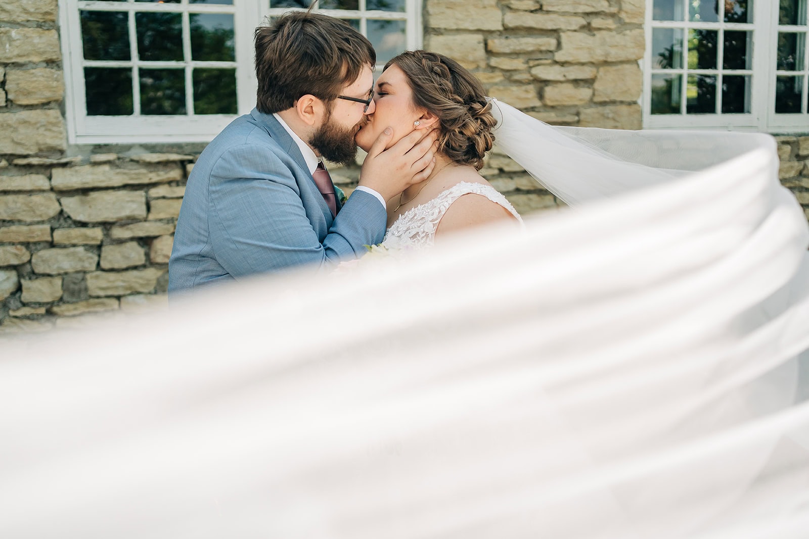 romantic portrait beside historic stone wedding venue in minnesota