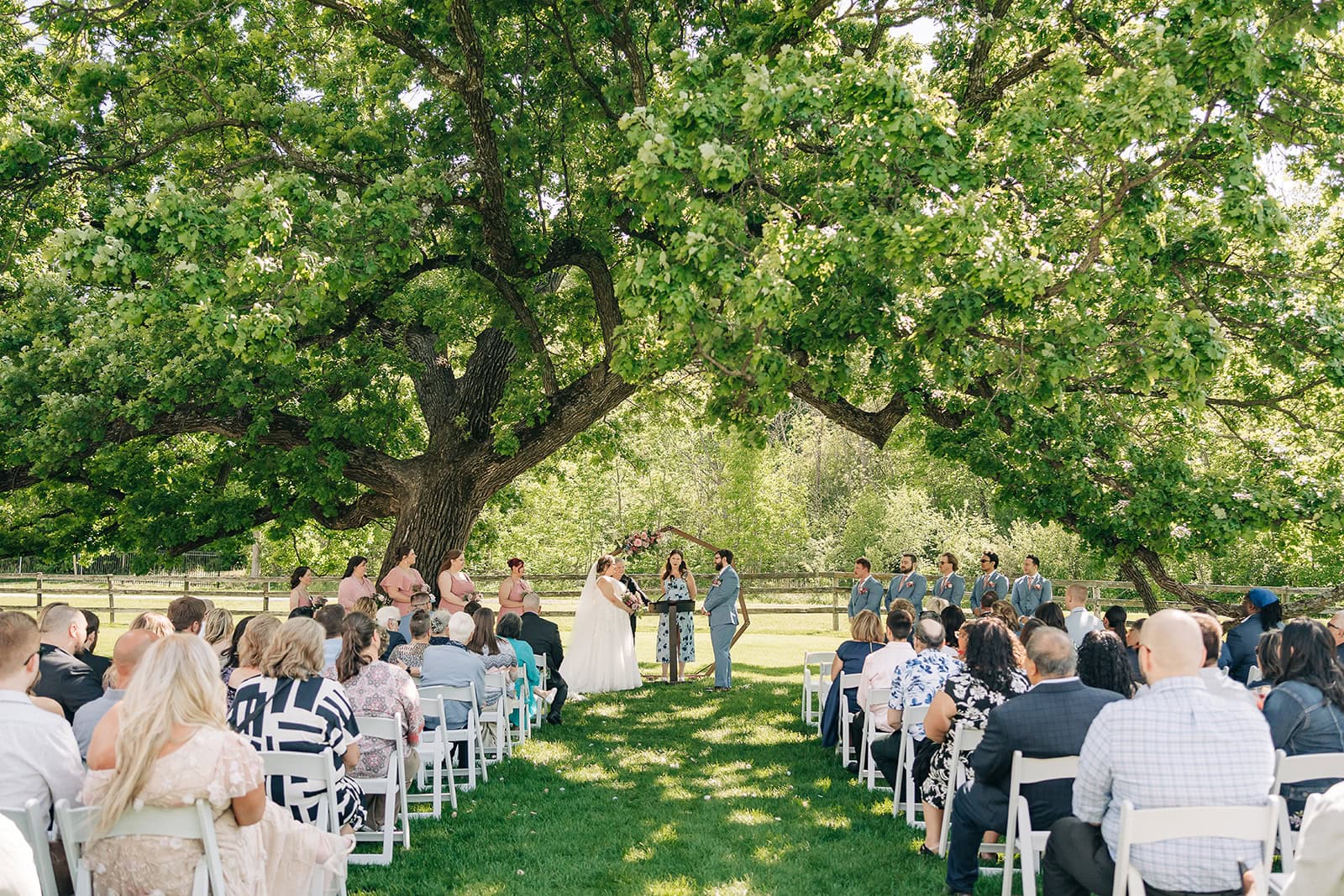 exchanging vows beneath Bur Oak at Minnesota wedding venue