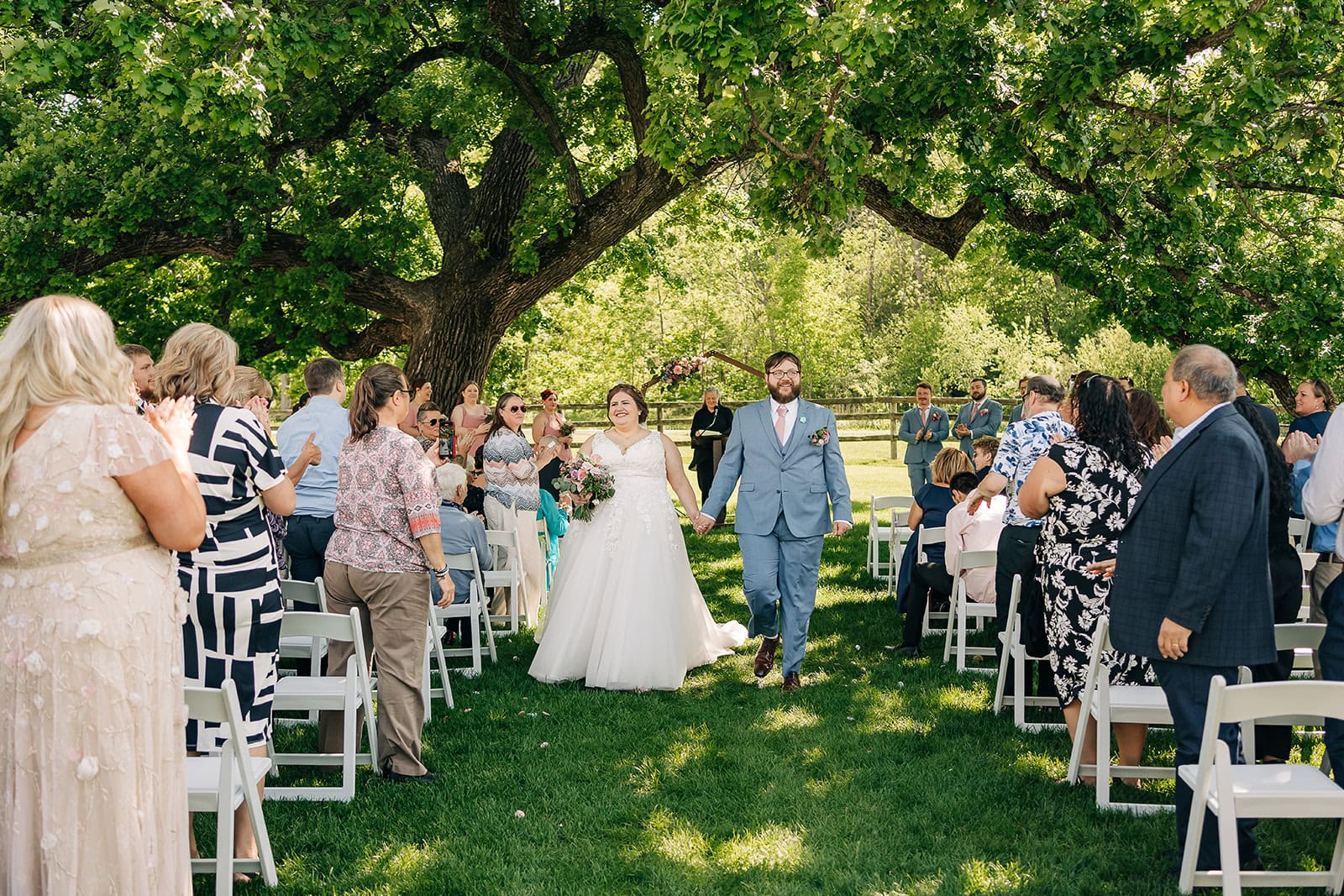 newlyweds walking down aisle at Rochester MN wedding venue