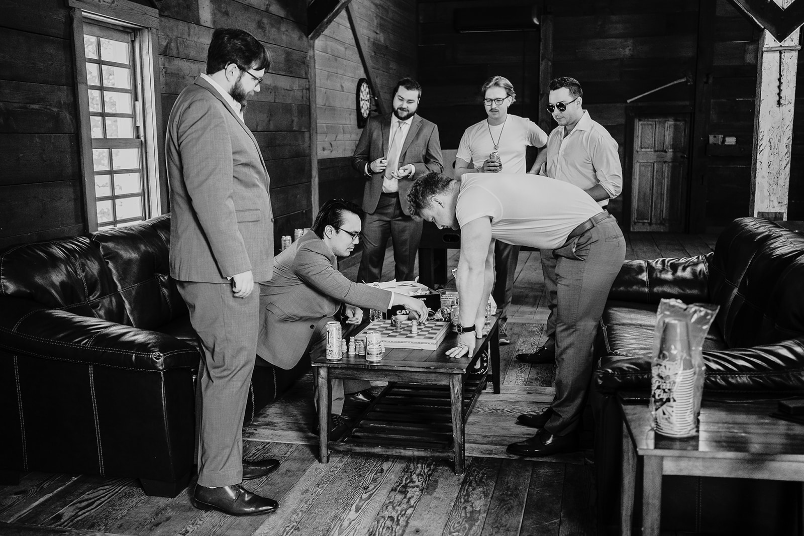 groomsmen playing chess on the morning of the wedding at Mayowood Stone Barn