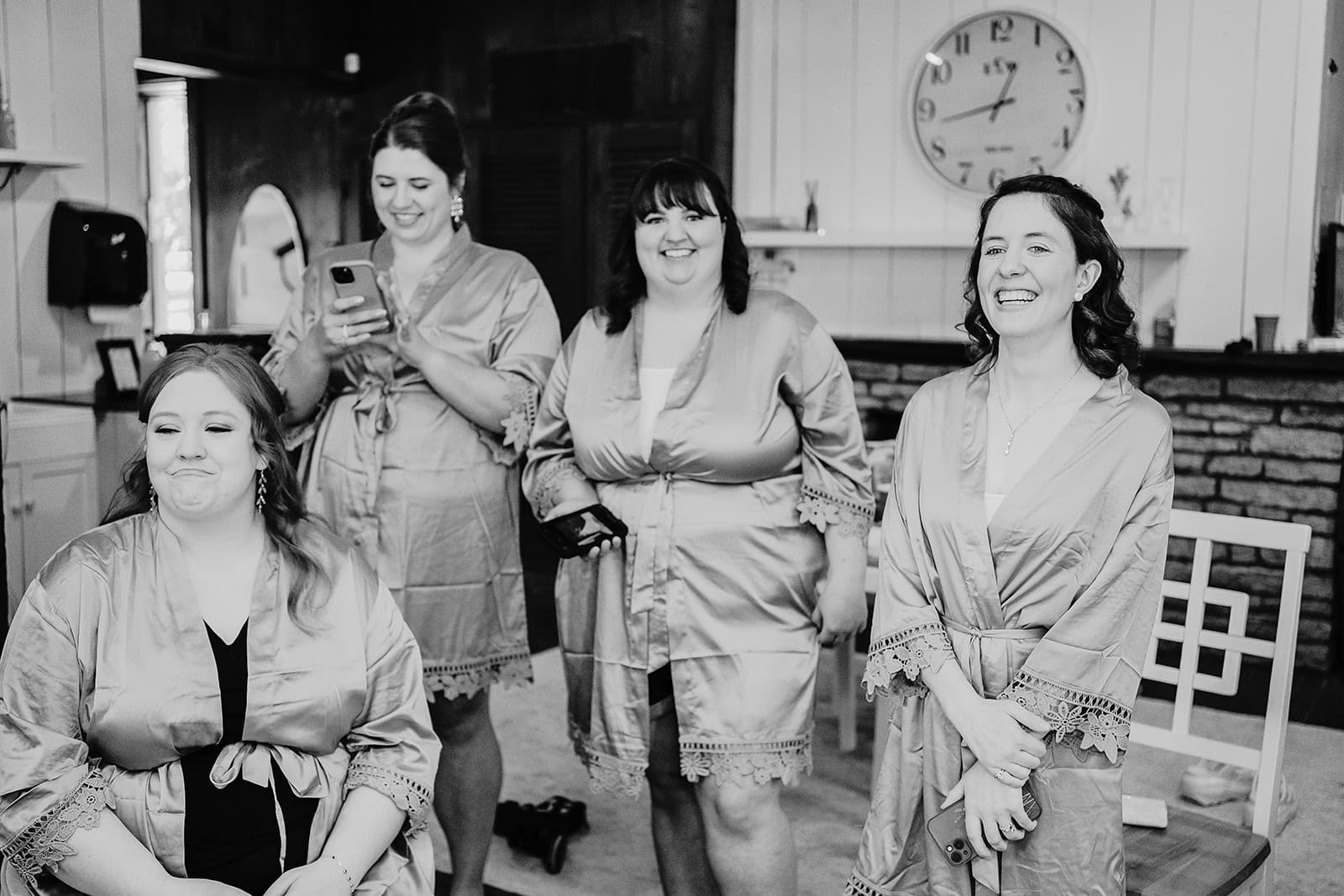 bridesmaids laughing while getting ready at historic stone barn